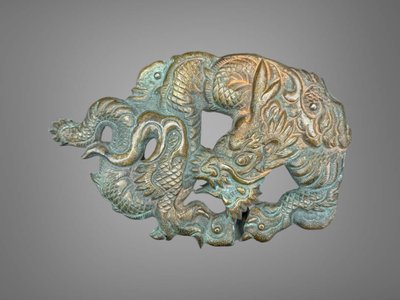 Embossed and finely engraved copper maedate featuring a dragon in clouds - Edo period. -