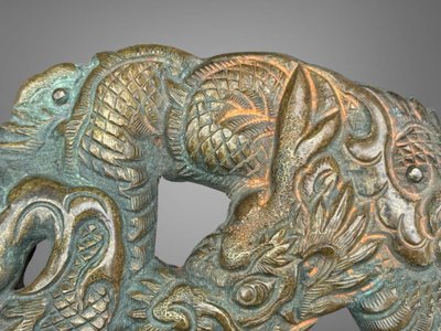 Embossed and finely engraved copper maedate featuring a dragon in clouds - Edo period. -
