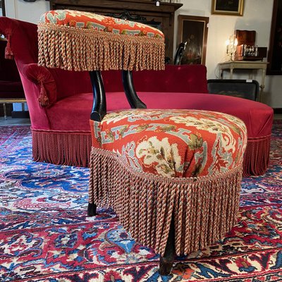 A Napoleon III period voyeur chair in blackened wood, upholstered in needlepoint tapestry