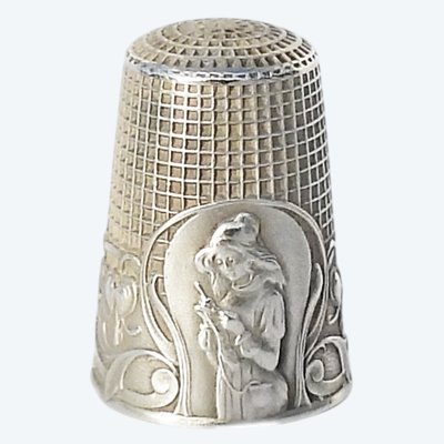Antique silver thimble illustrated with a young girl knitting in the early 19th century