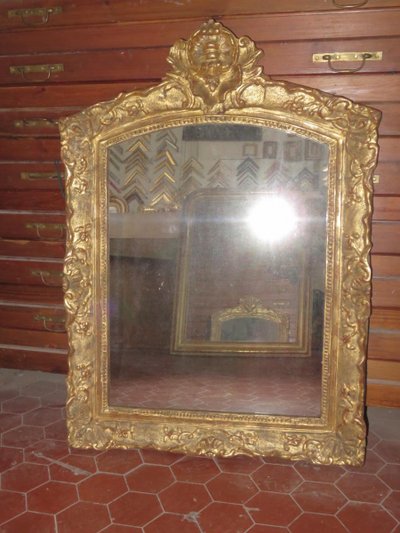 17th century Louis XIV style mirror in gilded wood.