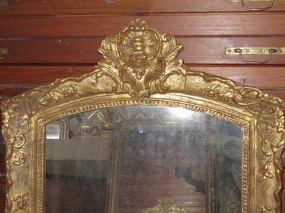 17th century Louis XIV style mirror in gilded wood.