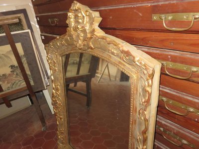 17th century Louis XIV style mirror in gilded wood.