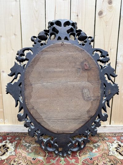 Miroir ovale en bois sculpté à tête de dragons
