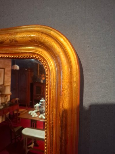 Louis-Philippe period mirror gilded with gold leaf.