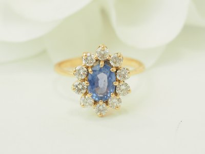 Yellow gold halo ring with a 1ct Ceylon sapphire and diamonds