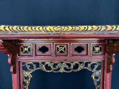 Decorative Asian-style side table in red and gold lacquered wood