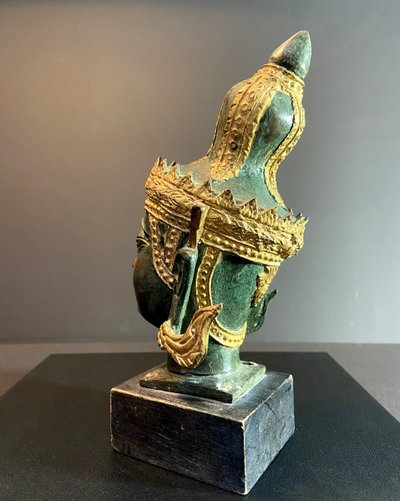Burma, mid 20th century, bronze Buddha head resting on a wooden base.