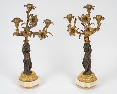 Pair of candelabra featuring putto figures, in patinated bronze and gilded bronze