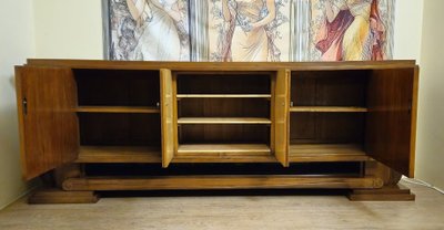 Importante enfilade époque Art Déco en noyer et cuir, reposant sur une élégante base architecturée 