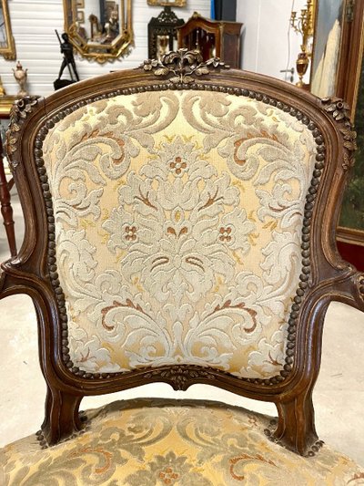 Pair of Louis XV armchairs in carved and gilded walnut, circa 1900