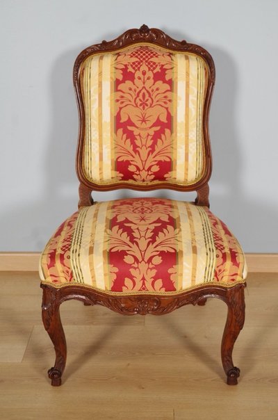 Set of four Regency-style chairs in carved walnut with flat backs, circa 1900