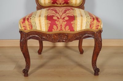 Set of four Regency-style chairs in carved walnut with flat backs, circa 1900