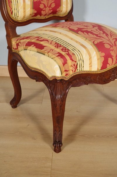 Set of four Regency-style chairs in carved walnut with flat backs, circa 1900