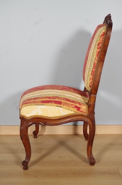Set of four Regency-style chairs in carved walnut with flat backs, circa 1900