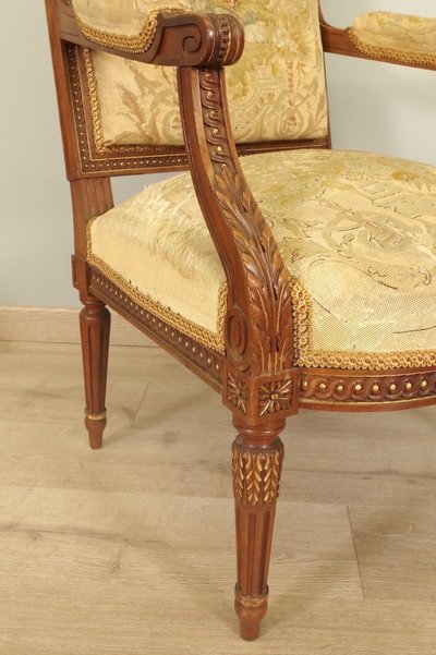 PAIRE DE FAUTEUILS LOUIS XVI EN NOYER DORÉ, TAPISSERIE AU PETIT POINT