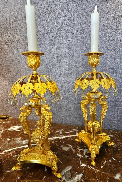 Pair of bronze candlesticks with eagles and tassels
