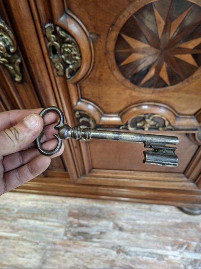 Richly molded and inlaid Louis XIV walnut cabinet – 18th century