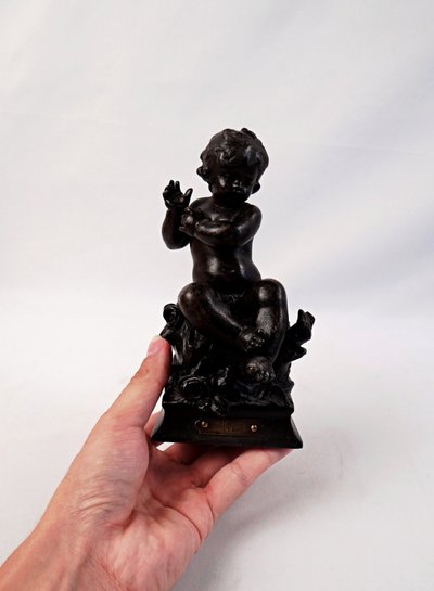 "The Child and the Lizard," a statuette in regul, with a brown patina, signed by Hyppolite Moreau, 19th century