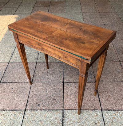 A Louis XVI-style eye table, made of walnut