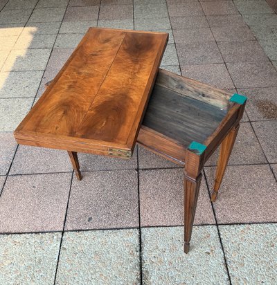 A Louis XVI-style eye table, made of walnut