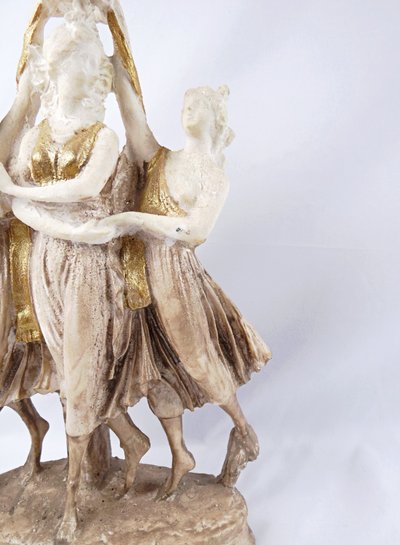 Sculpture titled "The Three Graces," made of white and gold resin, 20th century