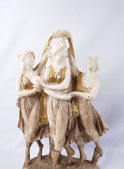 Sculpture titled "The Three Graces," made of white and gold resin, 20th century
