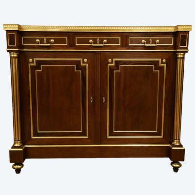 A striking sideboard made of mahogany and gilded bronze – White marble top – Louis XVI style 