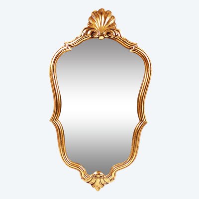 Louis XV-style wall mirror with rocaille design, shell-shaped pediment, wood, and gilded stucco; mid-20th century