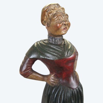 A 19th-century polychrome carved wooden caricature of a common woman.