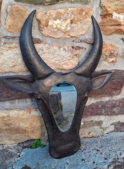 Metal mirror shaped like a cow's or bull's head
