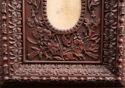 Richly carved, stained fruitwood oval picture frame, 19th century
