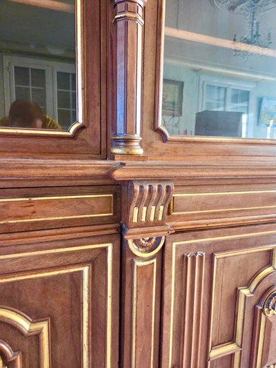Light walnut bookcase with arched doors