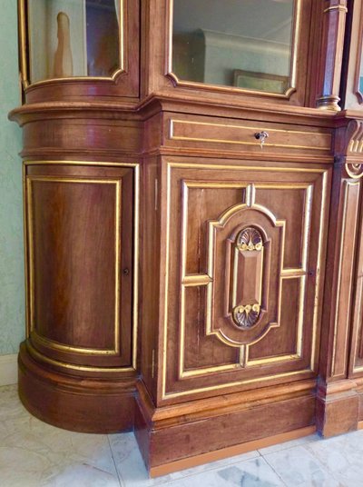 Light walnut bookcase with arched doors