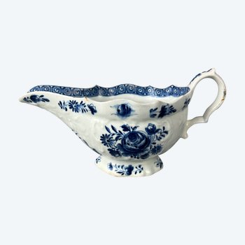 A mid 18thc Bow moulded sauceboat painted in underglaze blue c1765-70