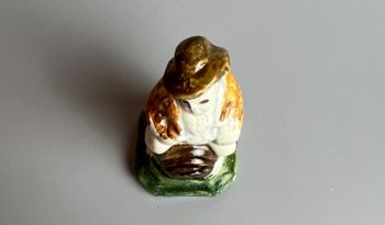 A c1790 Staffordshire pratt coloured pearlware toper figure seated on a barrel.