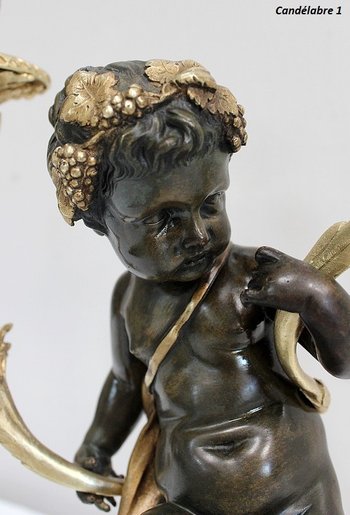 Coppia di candelabri in bronzo "Un Amour et un Faune", da Clodion e Delarue - Fine XIX secolo