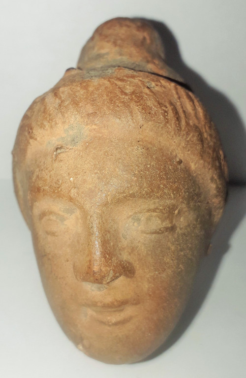 Antique head of a woman with a highlighted hairstyle raised in a high bun terracotta height 7.2 width 4 depth 5.5 cm
