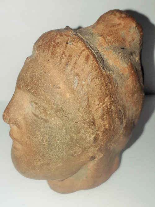 Antique head of a woman with a highlighted hairstyle raised in a high bun terracotta height 7.2 width 4 depth 5.5 cm