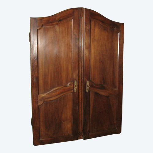 Pair of Louis XV style walnut paneled doors, 19th century