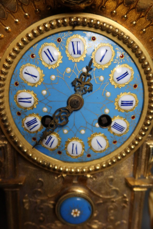 19th century clock with golden regula and colored enamelled earthenware