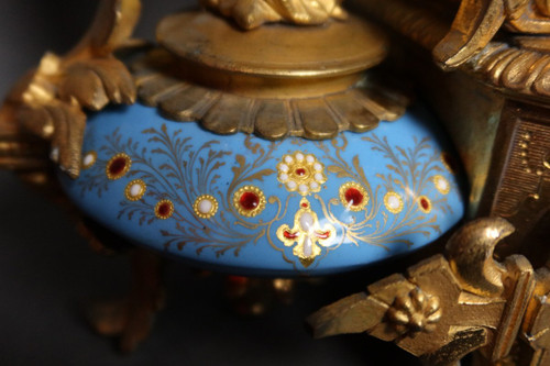 19th century clock with golden regula and colored enamelled earthenware