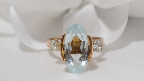 Rose Gold Ring Adorned With An Oval Aquamarine And Diamonds