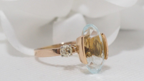 Rose Gold Ring Adorned With An Oval Aquamarine And Diamonds
