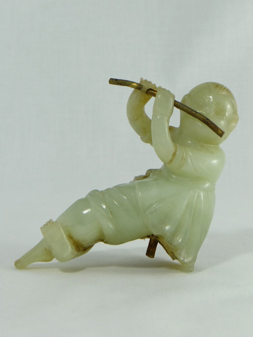 China Circa 1900, Jade Sculpture of a Child Playing the Flute.