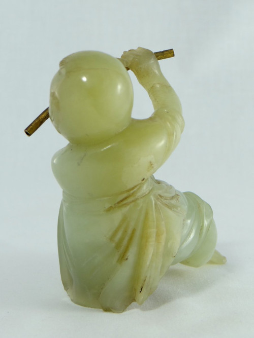 China Circa 1900, Jade Sculpture of a Child Playing the Flute.