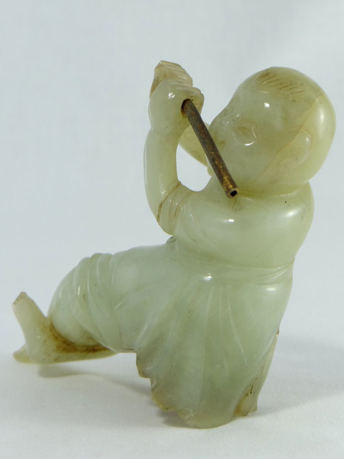 China Circa 1900, Jade Sculpture of a Child Playing the Flute.