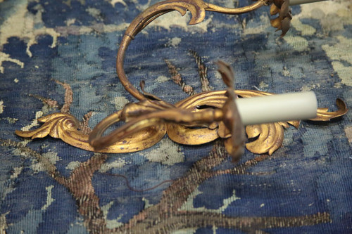 Suite of three gilded sheet metal sconces in the rocaille style.