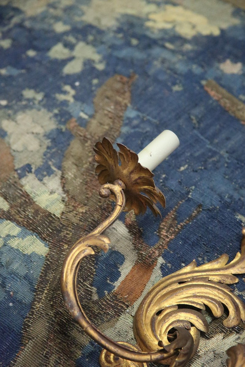 Suite of three gilded sheet metal sconces in the rocaille style.