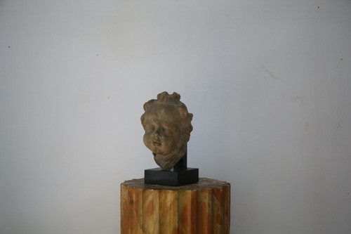 Grey stoneware sculpture of a child's face, Netherlands, early 18th century.